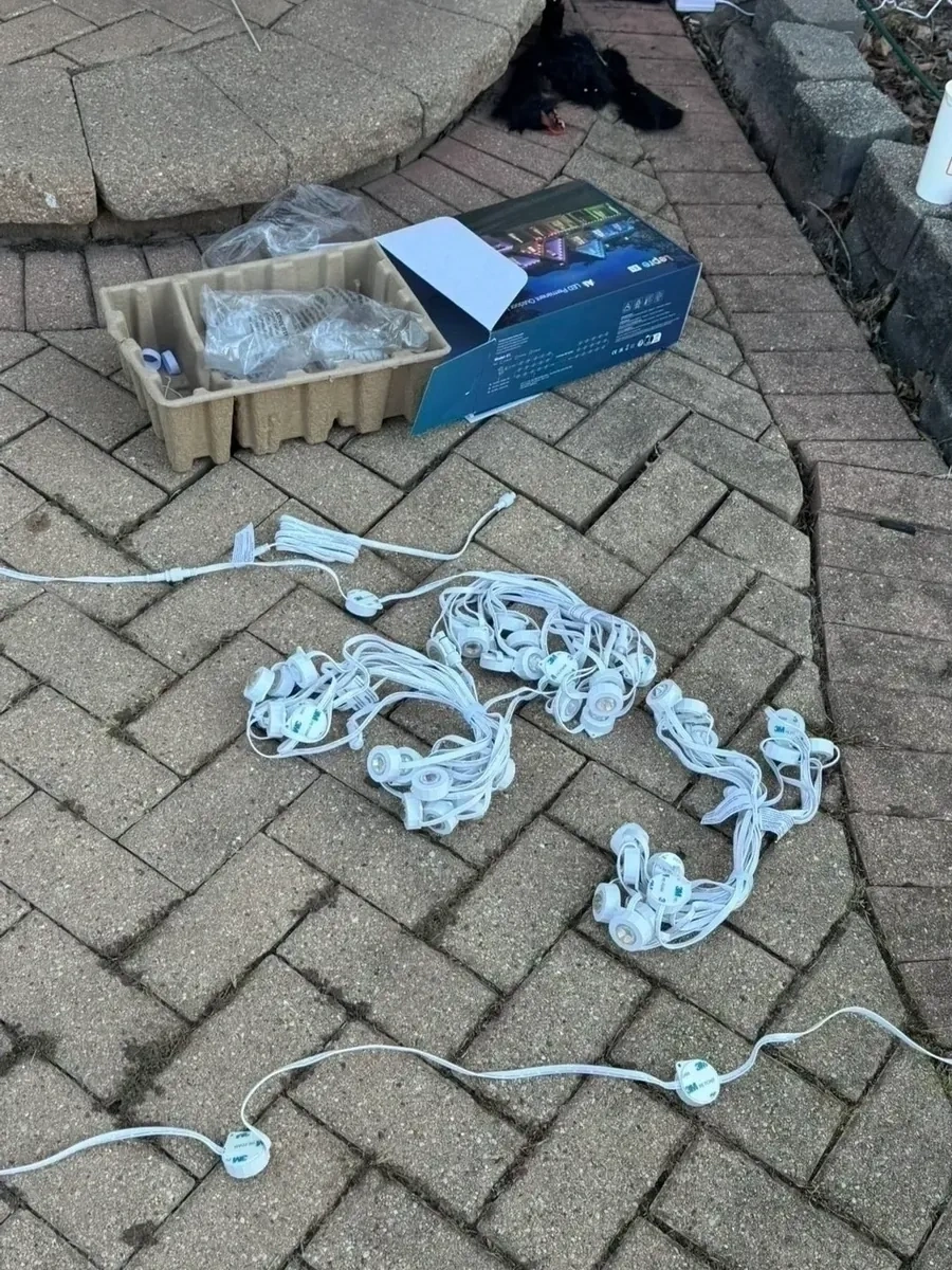 Smart LED permanent outdoor holiday lights unboxed and prepped before roofline installation - Bedford NY
