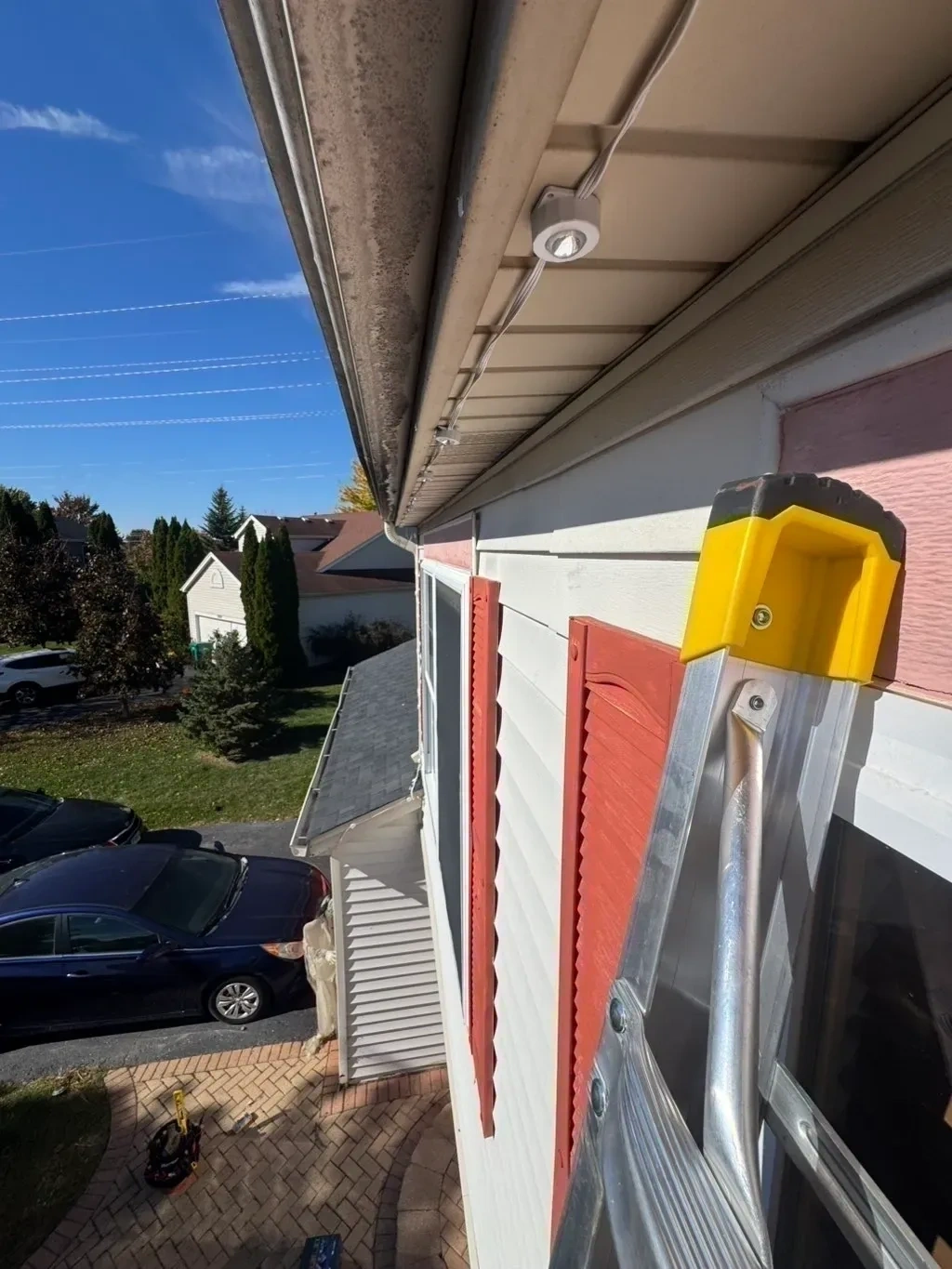 Permanent LED outdoor Christmas roofline lights installed along house soffits - Bedford NY