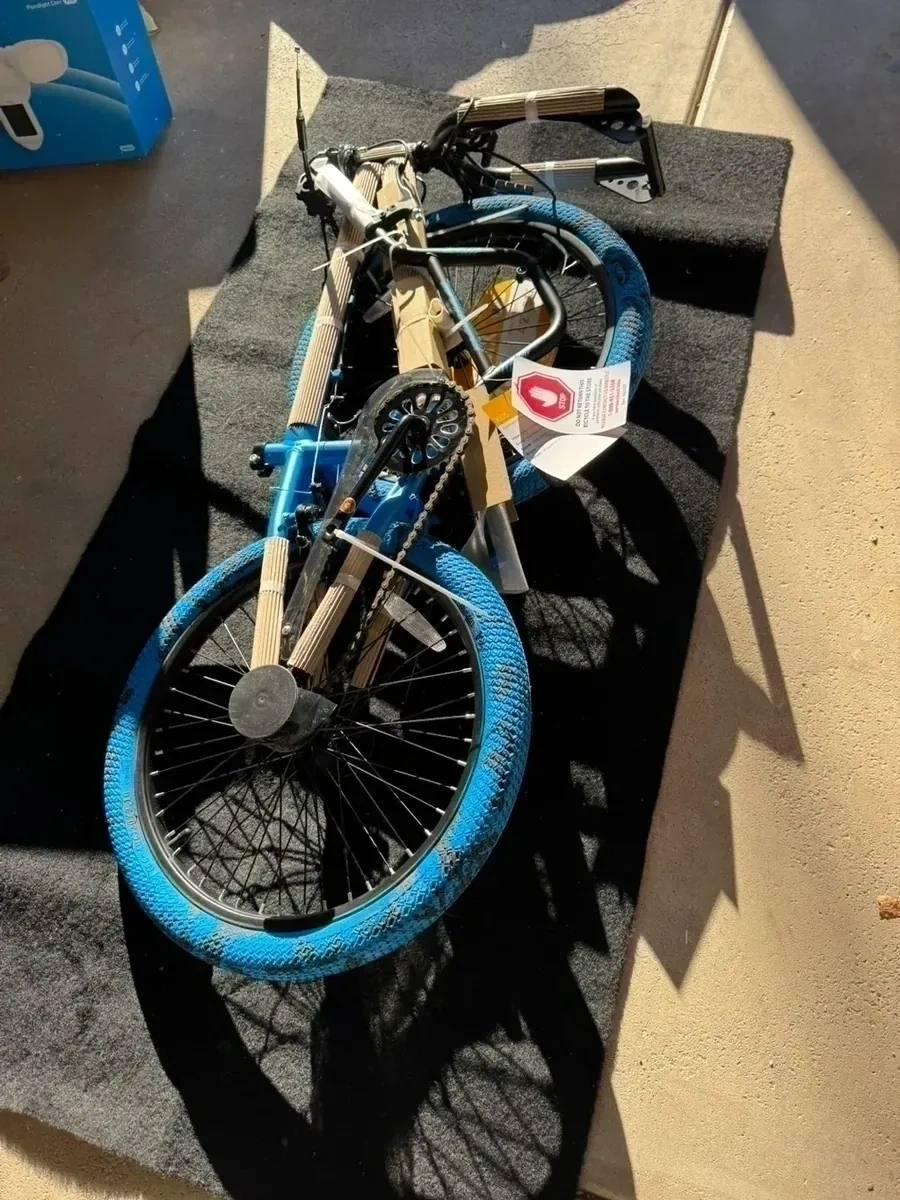 Unassembled blue BMX kids bicycle with protective frame padding before assembly - Dobbs Ferry NY