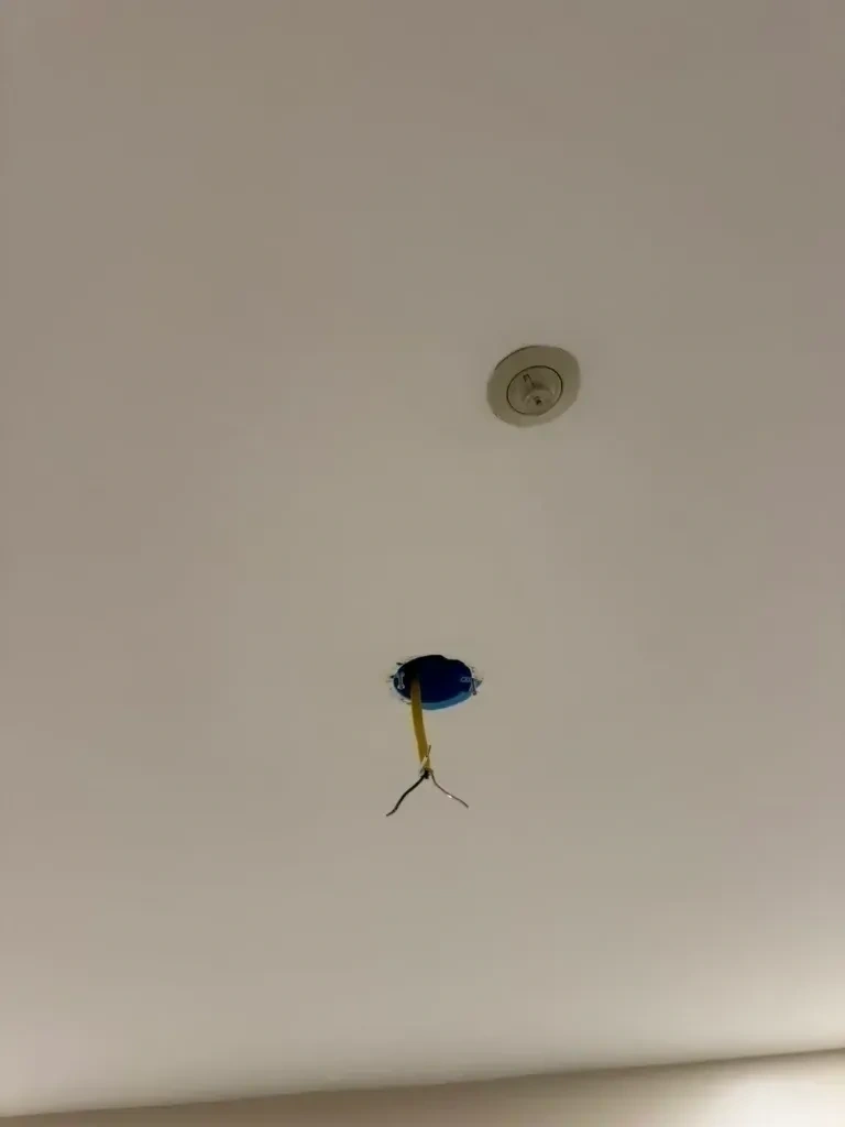 Ceiling electrical box cutout with stripped wire prepped for light fixture installation - Tarrytown NY