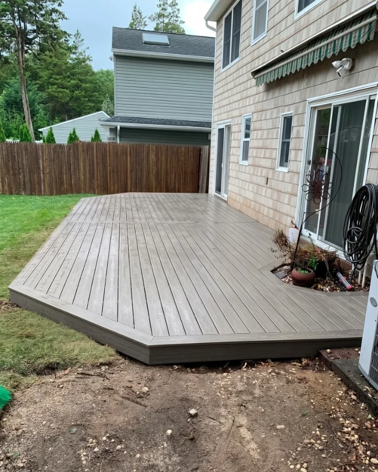 Completed luxury composite wood-grain deck with mitered picture frame borders - Rye NY