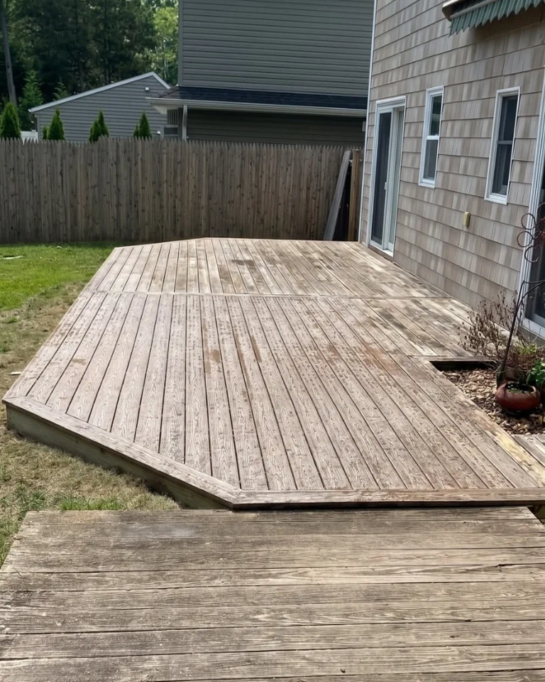 Old weathered grey wooden deck boards before composite replacement - Rye NY
