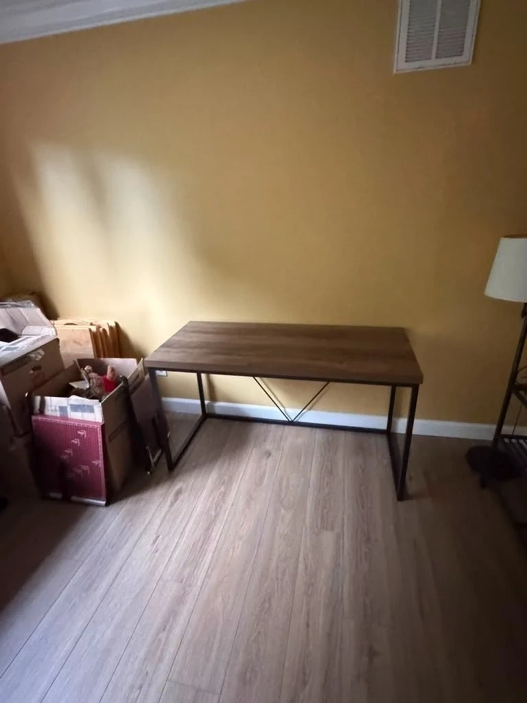 Modern dark wood top computer desk assembled and positioned along wall - Armonk NY