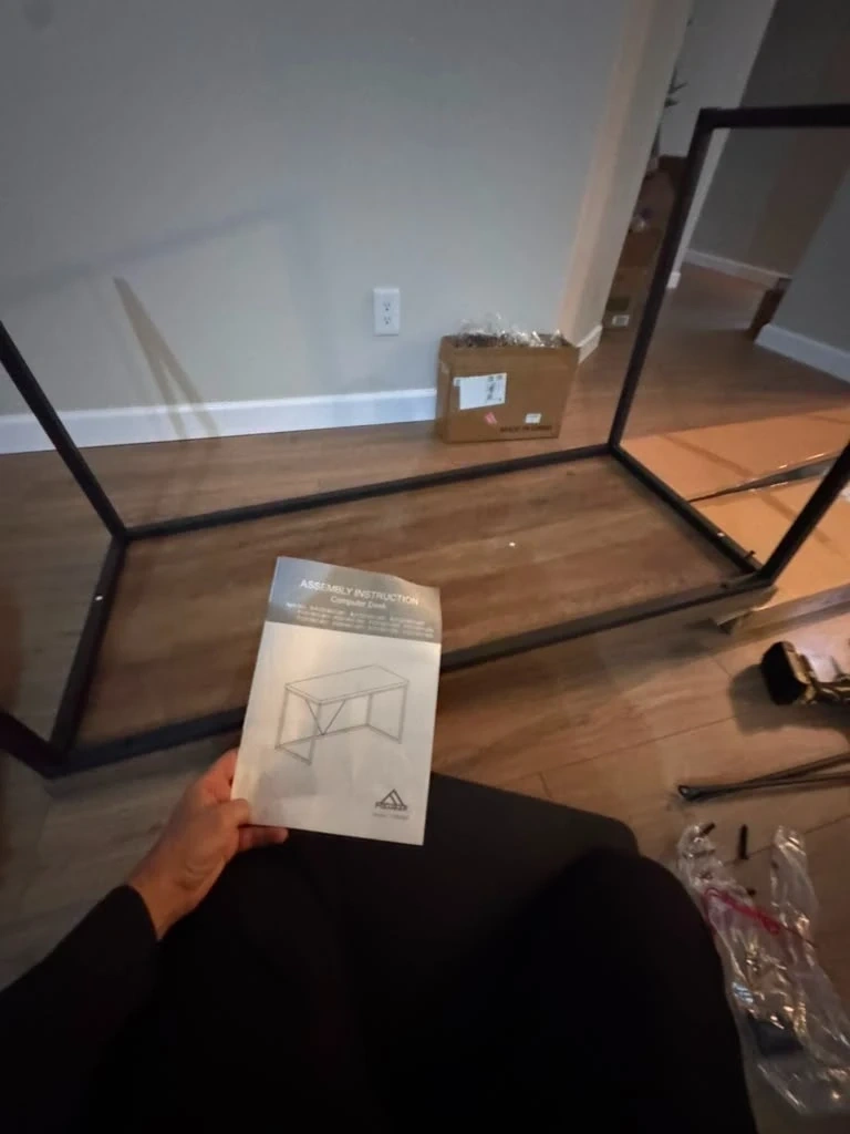 Unassembled metal computer desk frame and manual before assembly - Armonk NY