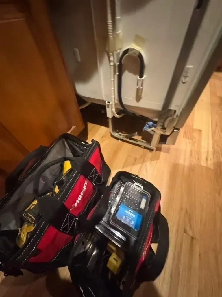 Stainless steel dishwasher un-crated with tool bags prepped for plumbing and electrical connection - New Rochelle NY