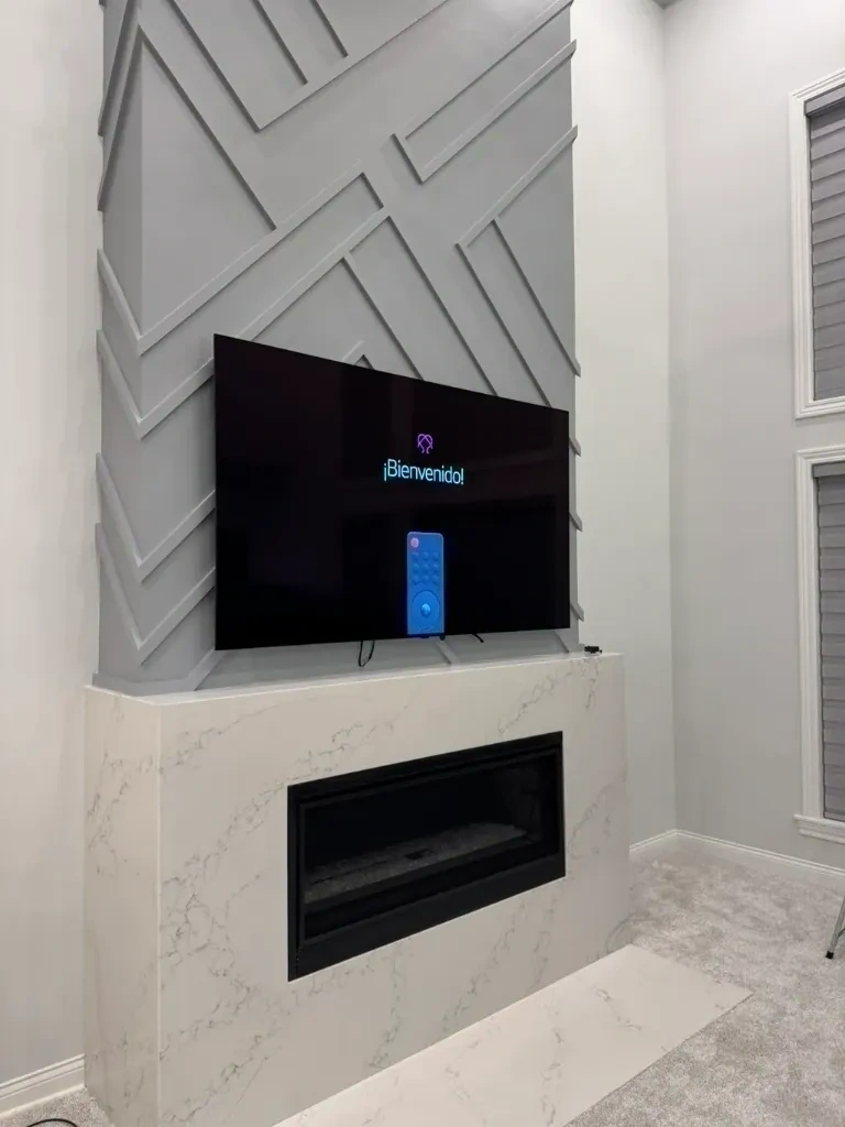 Smart TV mounted over fireplace with clean hidden cables - Scarsdale NY