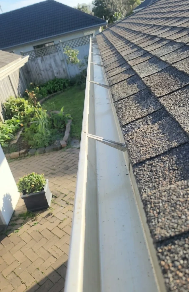 Clean flushed roof gutter channel free of leaves and water obstruction - Scarsdale NY
