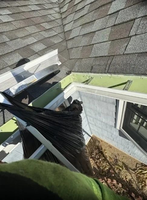 Roof valley debris cleanup before gutter guard installation - Chappaqua NY