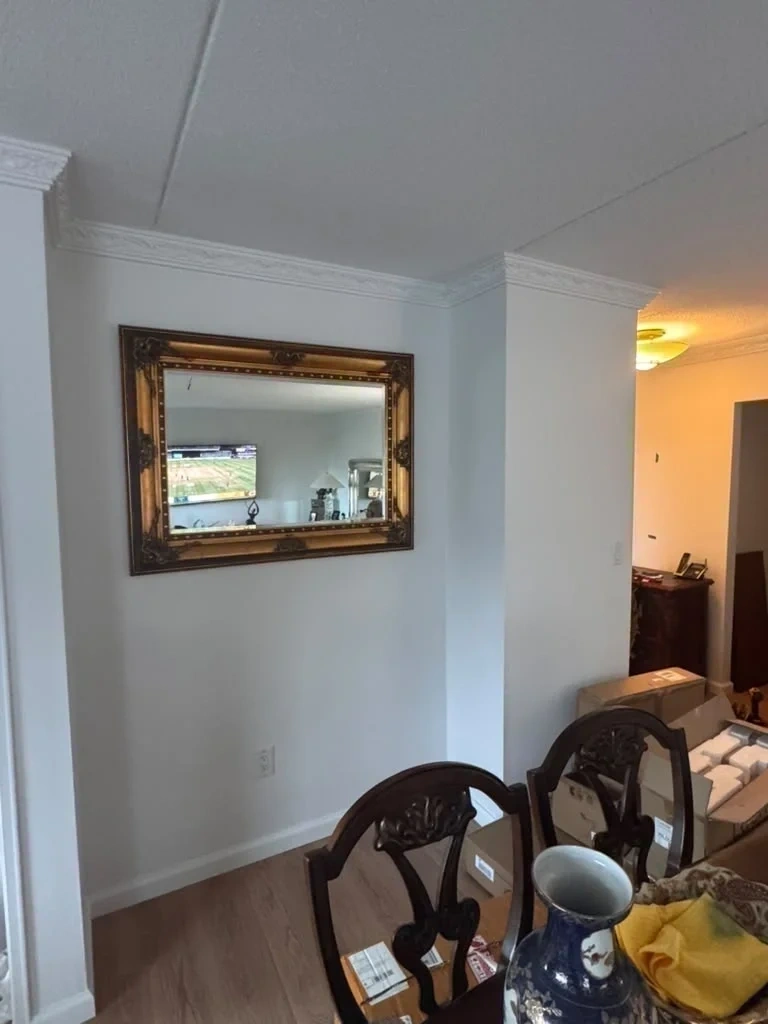 Large gold ornate carved frame mirror mounted level in dining alcove - Larchmont NY