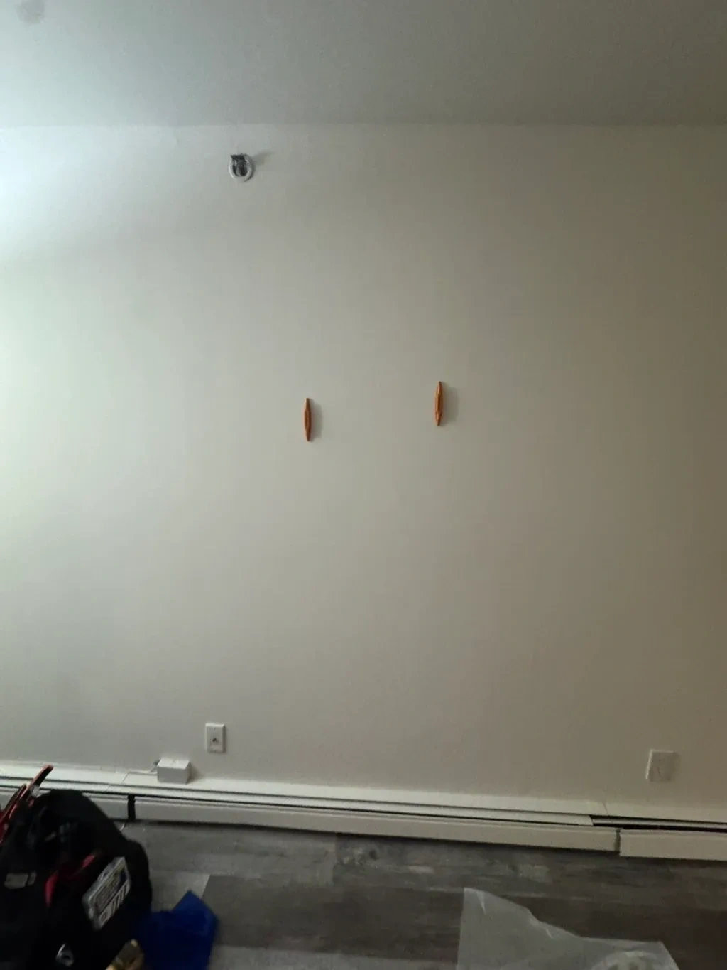 Living room wall prepped and marked with stud anchors before TV wall mounting - Tarrytown NY