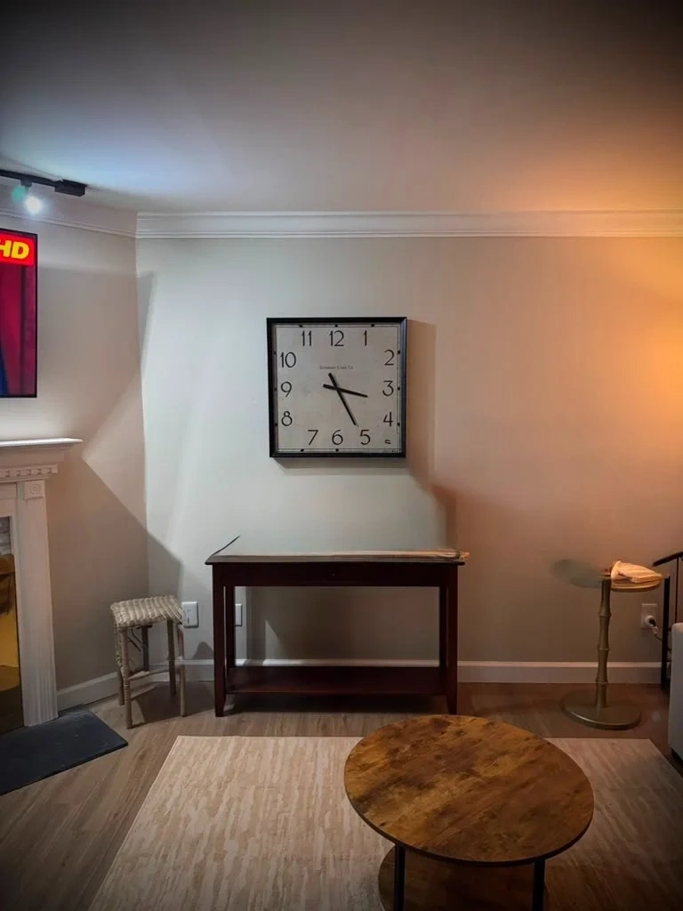 Large square decor wall clock mounted level on living room wall - Rye NY