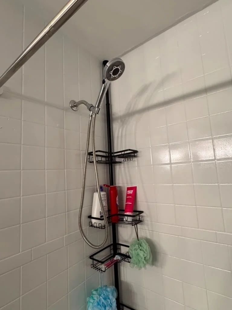 Handheld LED showerhead mounted on shower arm with water off - Rye NY