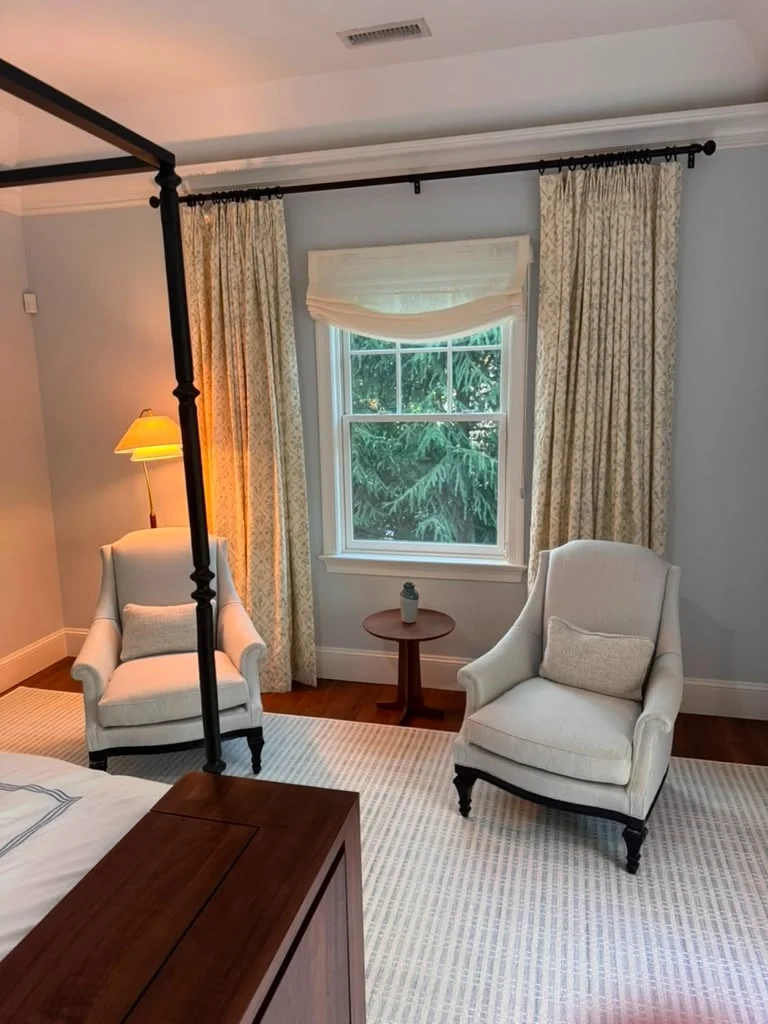 Installed matte black iron curtain rod with French-pleat floral drapes in Bedford NY
