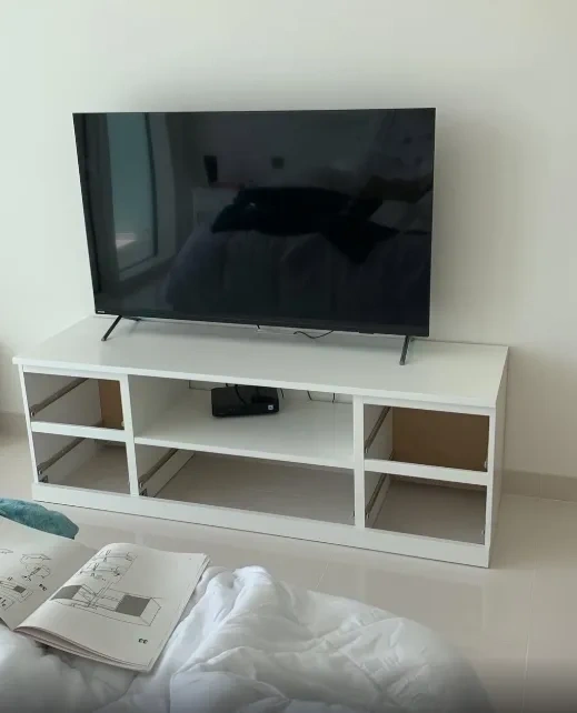 Assembled white TV stand and media console with TV placed on top - Scarsdale NY