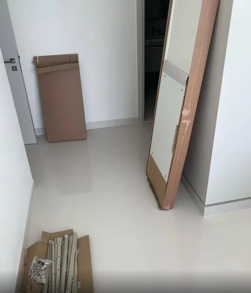 Unboxed flat-pack media console panels and parts before assembly - Scarsdale NY