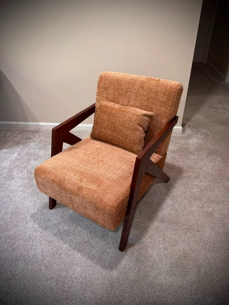 Assembled mid-century modern terracotta accent armchair with angular wood frame in Bronxville NY