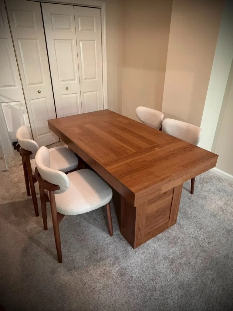 Assembled wood pedestal dining table and 4 modern curved-back dining chairs in Rye NY