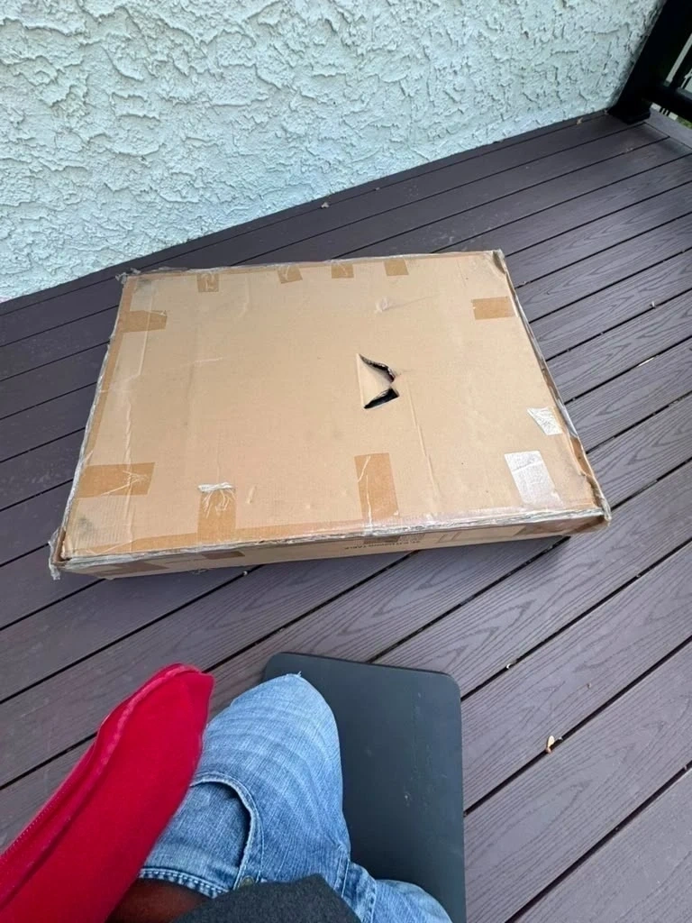 Flat-pack outdoor patio table box on deck before assembly - Harrison NY