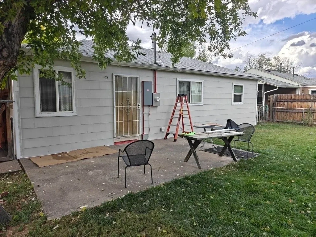 Estate backyard patio and unpainted house exterior before makeover - Bedford NY