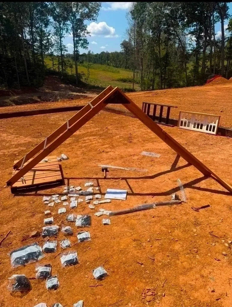Wooden playset parts and frame laid out before assembly - Yonkers NY