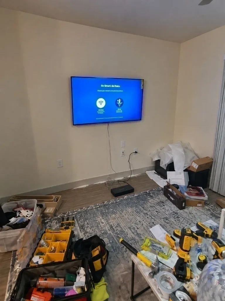 Illuminated Roku Smart TV mounted flush to living room wall - Dobbs Ferry NY