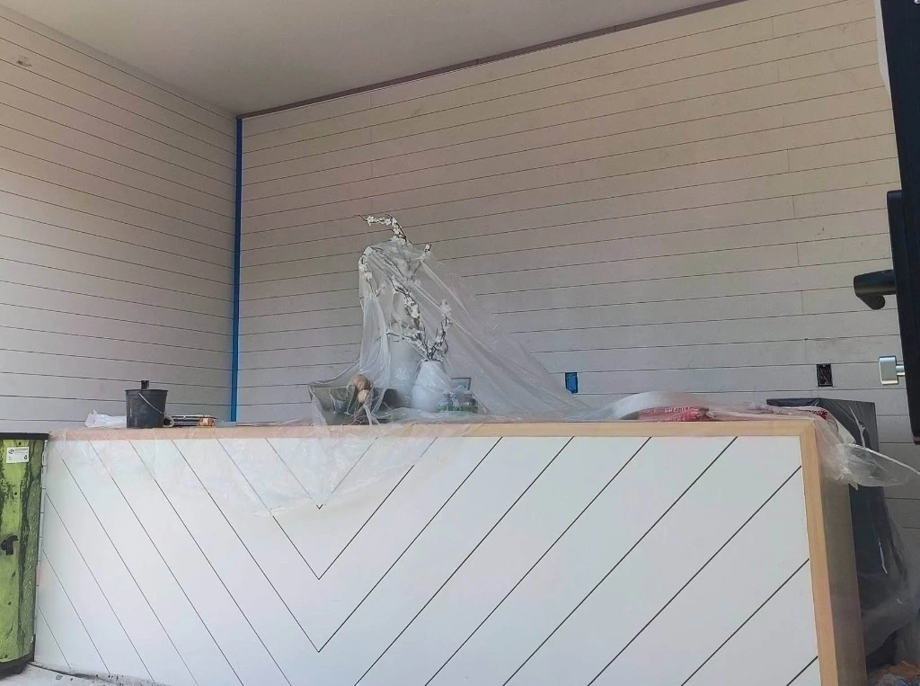 Boutique Commercial Sage Green Shiplap Feature Wall before repair in Bronxville, NY (10708)