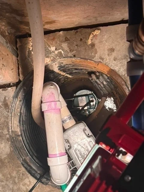 New submersible sump pump installed in basement pit with check valve - Scarsdale NY