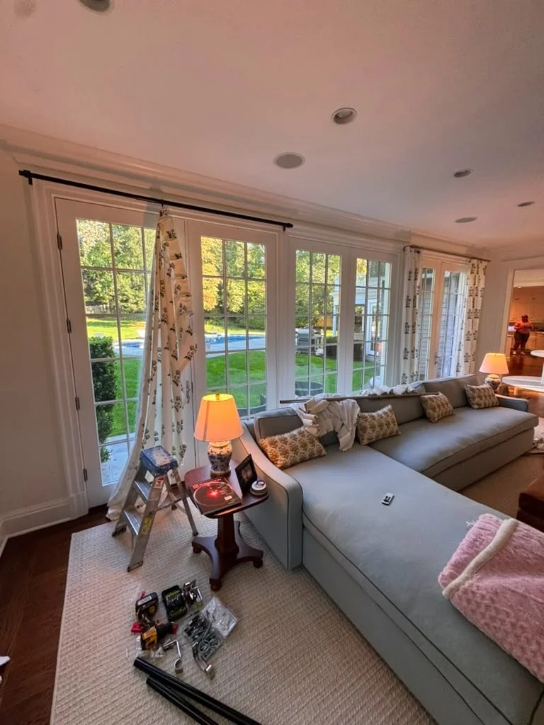 In-progress curtain rod and drapery installation across French doors in Armonk NY