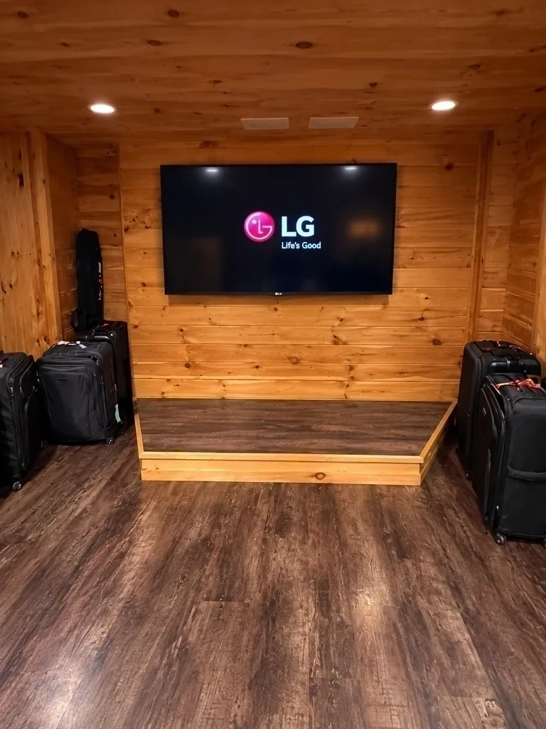 Large LG flat screen TV mounted cleanly on wood panel wall with in-wall wire hiding - Ardsley NY