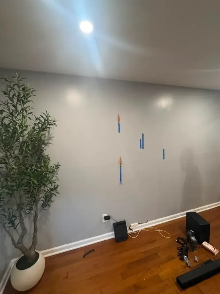 Living room wall prepped and marked with stud locators before TV wall mounting - Larchmont NY