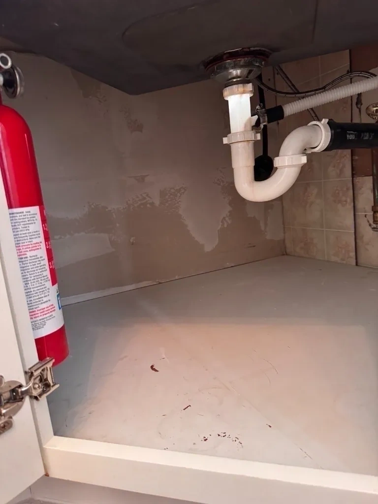 Installed moisture-resistant drywall backing and sealed under sink cabinet wall closure - Chappaqua NY
