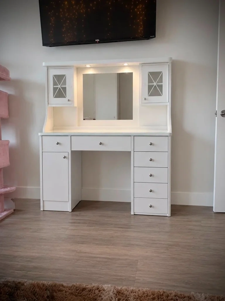 White lighted vanity desk with mirror and glass cabinet doors assembled in bedroom - Tarrytown NY