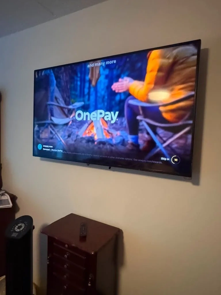 Vizio smart TV mounted level on living room wall above console - Yonkers NY