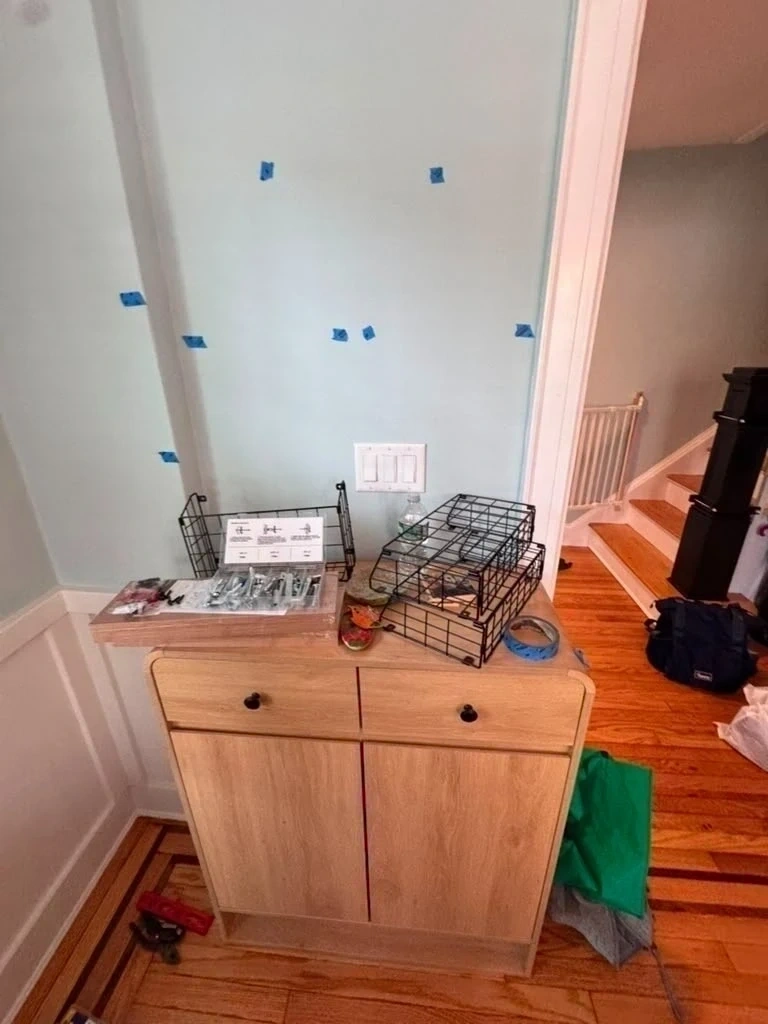 Wall layout with painter tape marks before wire basket installation - Hastings-on-Hudson NY